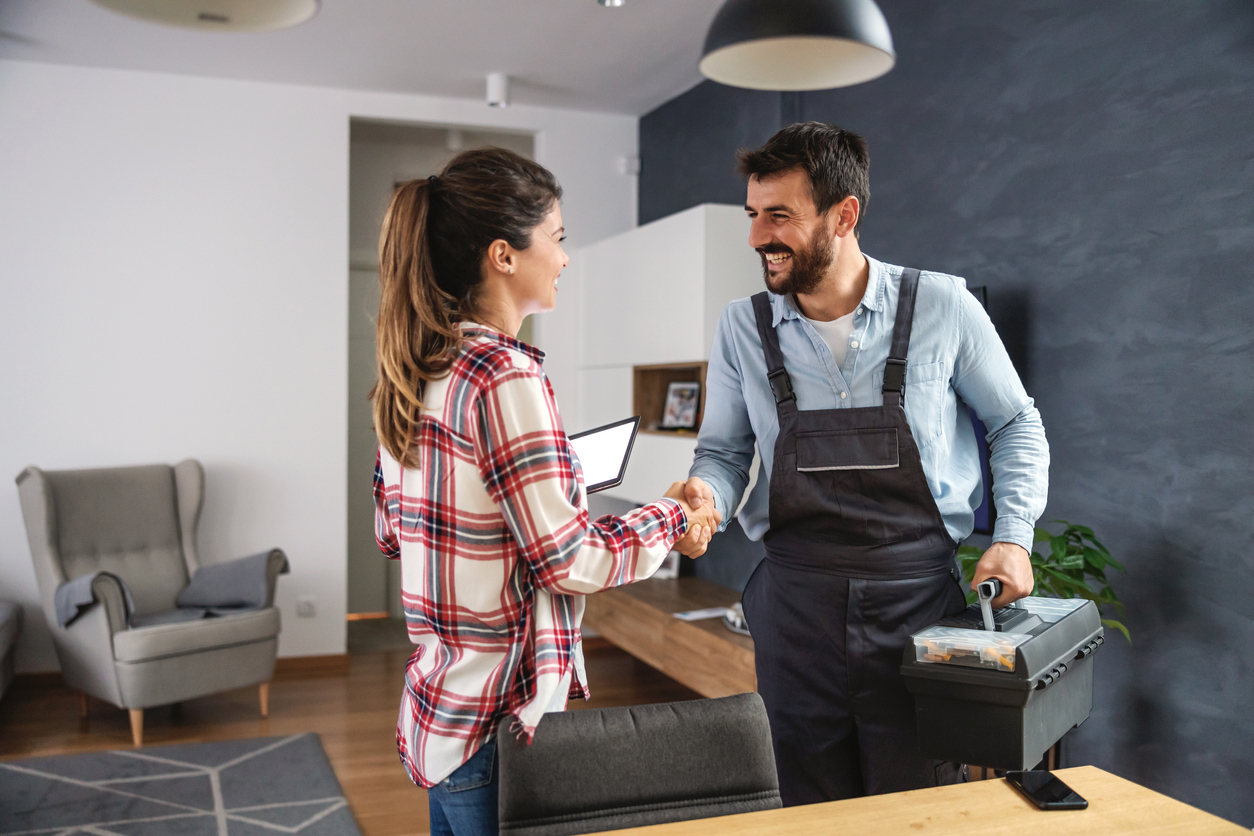 Women shakes hand with emergency restoration contractor.