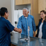 Emergency restoration contractor communicates with happy homeowners about their home's project status.