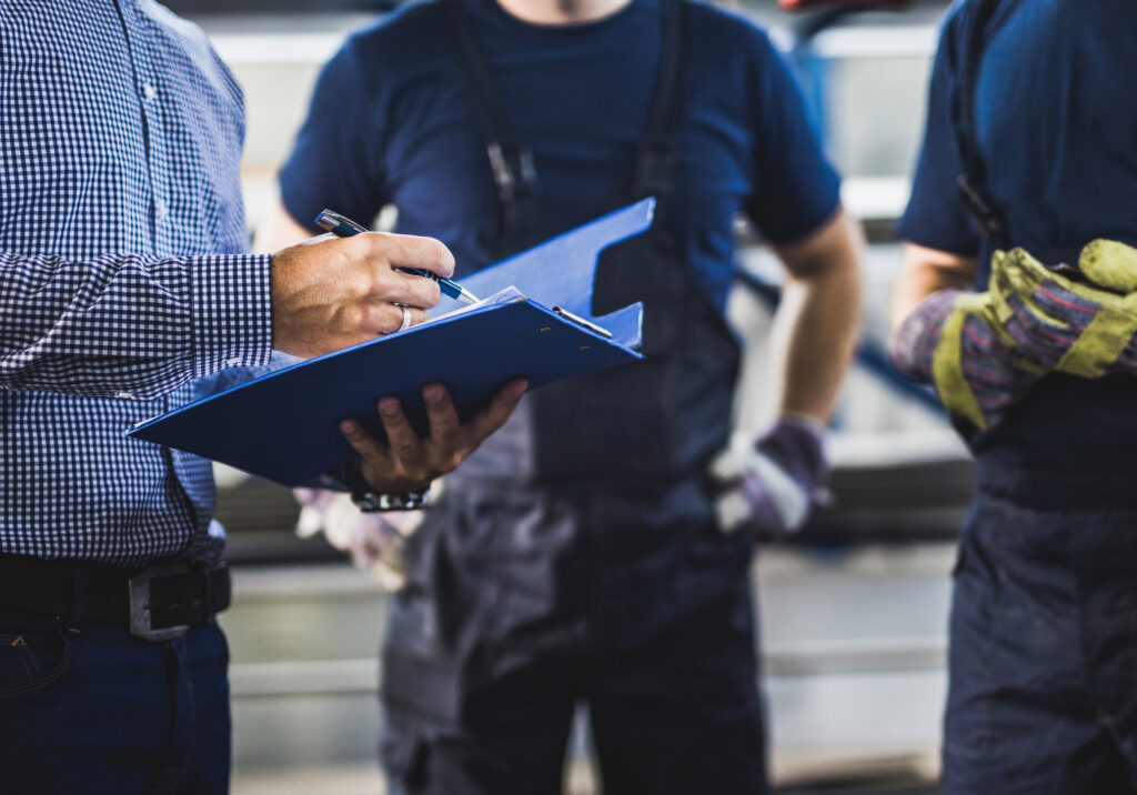 A contractor using restoration company billing services discusses documentation with restoration technicians.