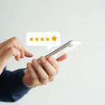 Customer leaves a 5-star restoration business review using their smart phone.