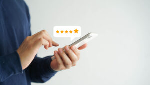 Customer leaves a 5-star restoration business review using their smart phone.